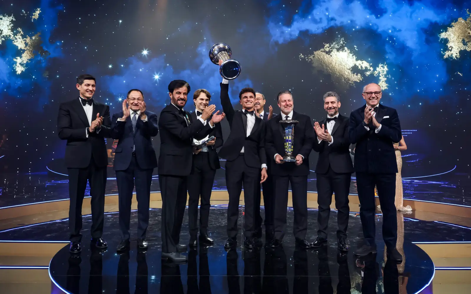 Cover Image for Norris gets his hands on F1 trophy as unwell Verstappen stays away